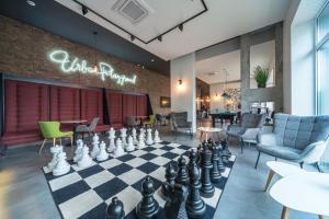 a lobby with a chess board and a room filled with furniture at Amarant Apart Hotel by CHM in Kyiv +30 photos