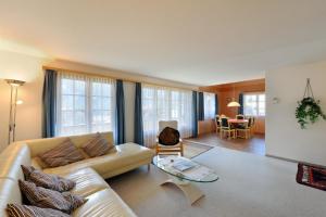 a living room with a couch and a table at Apartments Kirchbühl in Grindelwald +27 photos