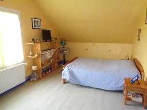 a bedroom with a bed and a large window at La Moutte in Lhommaizé