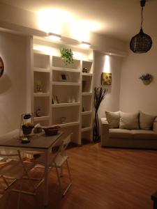 a living room with a table and a couch at Casa Vacanze Cinecitta'est in Rome