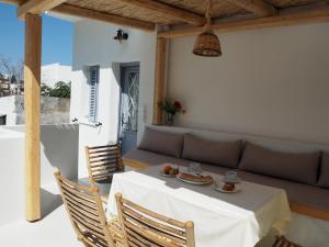 a table and chairs on a patio with a couch at Stella's Home: Old Town Traditional Cretan House in Heraklio