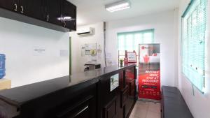 a kitchen with a black counter top in a room at RedDoorz @ Picas Sagkahan Tacloban in Tacloban