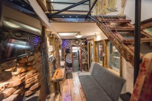 a train room with a staircase and a couch at Rent a Room - Be Rustic in Braşov