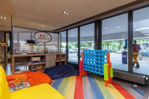 a childrens play room with a lot of games at a&o Amsterdam Zuidoost in Amsterdam