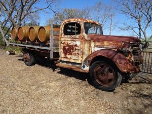 an old rusty truck with barrels on the back at Redgate Country Cottages in Moffatdale