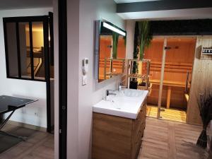 a bathroom with a sink and a mirror at L'Atypique Vosgien in Bussang +16 photos