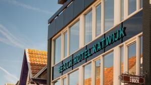 a building with a sign on the side of it at Beach Hotel Katwijk in Katwijk
