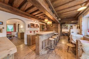 a kitchen with a bar and some wooden ceilings at Ferienhaus Olpererblick in Tux