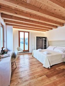 a bedroom with two beds in a room with wooden ceilings at Locanda del Delta in Comacchio