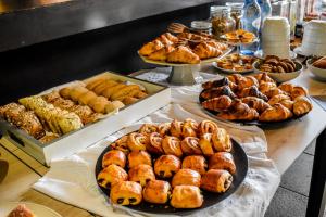 a buffet of pastries and other pastries on a table at Volcanic Charming House in Ribeira Grande