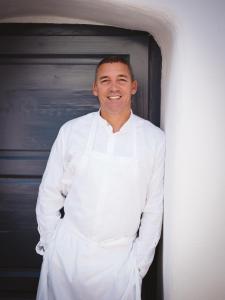 a man in a chefs outfit standing in a doorway at Relais & Châteaux Taubenkobel in Schützen am Gebirge