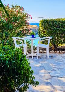 a white table and two chairs on a patio at Studios Marfo in Batsi