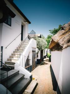 a group of stairs next to a white building at Relais & Ch&acirc;teaux Taubenkobel in Sch&uuml;tzen am Gebirge