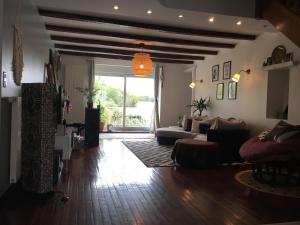 a living room with a couch and a table at Emel b&b in Laville-aux-Bois