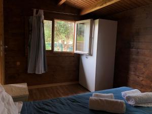 a bedroom with a bed and a window at Quinta da Joia in Silves