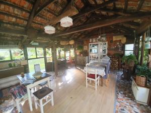 an overhead view of a living room with tables and chairs at Village House Flowerside in Gospić