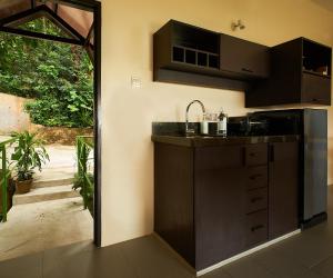 
a kitchen with a sink and a counter top at Ambong-Ambong Langkawi Rainforest Retreat in Pantai Cenang
