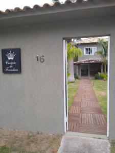 a door leading to a house with a walkway at Casarão da Ferradura B&B in Búzios