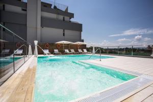 a swimming pool on the side of a building at Hotel Gala in Misano Adriatico