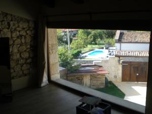 a room with a large window looking out at a swimming pool at Venezia delle Nevi in Budòio