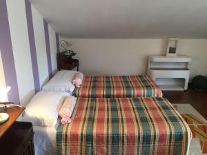 a bedroom with two beds in a room with stripes at Cà 'd Gnese in Castagnole Lanze