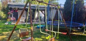 a playground with a swing set in a yard at Domki w BOSZKOWIE in Boszkowo