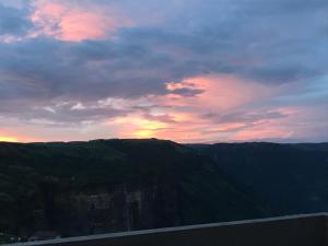 a sunset on top of a mountain with a highway at Aisha Guest House Bed & Breakfast in Cherrapunji