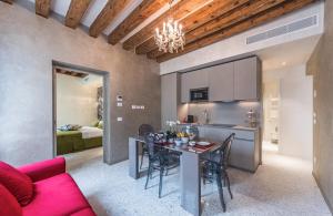 a kitchen and living room with a table and chairs at Rialto Luxury Flat in Venice