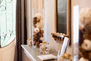 a glass vase with a teddy bear on a table at La Poterne l Chambres d'hôtes à Epernay in Épernay +69 photos