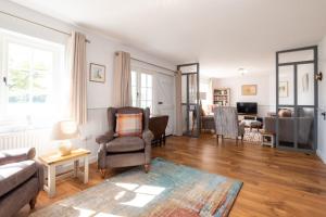 a living room with a couch and a chair at 5 The Haven in Thorpeness