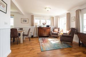 a living room with a table and chairs at 5 The Haven in Thorpeness