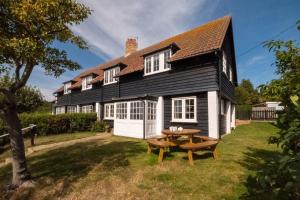 a house with a picnic table in front of it at 5 The Haven in Thorpeness
