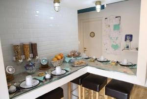 a kitchen with a counter with food on it at House SottoCoperta in Civitavecchia