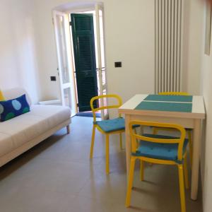 a living room with a table and chairs and a couch at Il Patio in Manarola +23 photos
