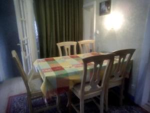 a dining room table with chairs and a colorful table cloth at Pension Panorama in Gersfeld