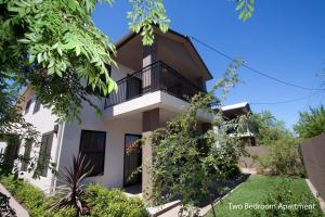 a house with a balcony and trees at The Charles Boutique Hotel & Dining in Wagga Wagga