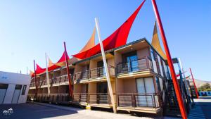 a building with red and orange flags on it at Hotel Vento in Copiapó