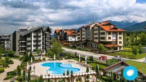 a resort with a swimming pool and some buildings at Stylish Studio Apart Aspen Golf Resort in Razlog