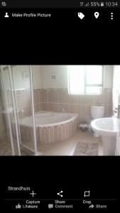 a picture of a bathroom with a tub and a toilet at Salt Life in Port Shepstone