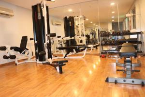a gym with lots of machines and a mirror at Swan Towers in Juffair