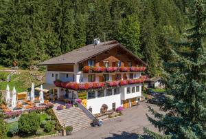 an aerial view of a house with flowers on it at Hotel Pontives in Ortisei