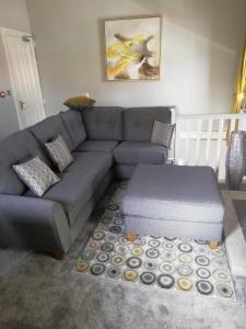 a living room with a gray couch and a coffee table at Bolands Self Catering Accommodation in Hacketstown