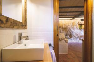 a white sink in a bathroom with a shower at Casa rural Mas del Serranet in Horta de San Joan +99 photos