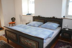 a bedroom with a bed with two pillows on it at Die Seele baumeln lassen in der Alten Druckerei in Viechtach