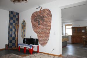 a living room with a wall with a brick wall at Die Seele baumeln lassen in der Alten Druckerei in Viechtach