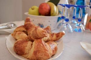 a plate of croissants and apples on a table at Villa Luisa B&B in Candelo
