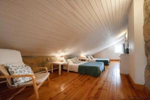 a bedroom with two beds and a wooden ceiling at OportoHouse in Porto