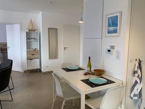 a dining room with a white table and chairs at LE CLOS SAINTE MARIE in Pornic