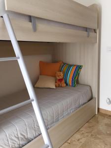 a teddy bear sitting on the bottom bunk of a bunk bed at Casa Bianca in Frabosa Sottana