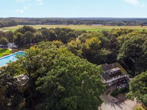 an aerial view of a mansion with a pool and trees at Hotel Hopener Wald ,Self Check In in Lohne